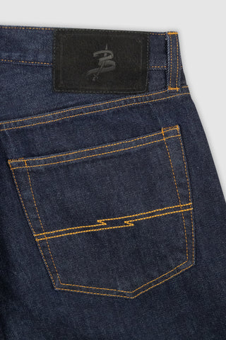 Detailed close-up of the branded leather patch on the waistband of Barbanera Bandito dark rinsed jeans, highlighting craftsmanship and heritage-inspired design.