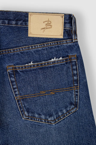 Detailed view of Barbanera Bandito jeans leather patch with branding engraving on back waistband