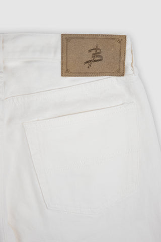 Close-up detail of the Barbanera Bandito off-white jeans, highlighting the branded leather patch on the back waistband.