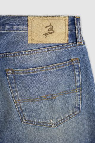 Detailed view of Barbanera Bandito jeans leather patch with branding engraving on the back waistband