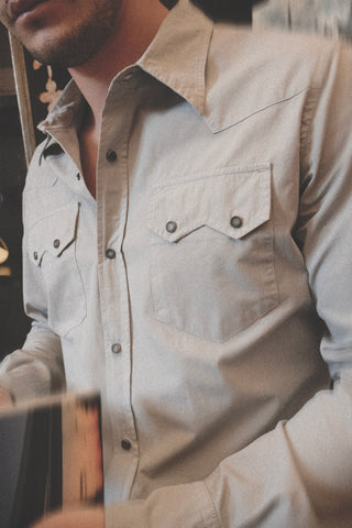 Lifestyle close-up of the Barbanera Carlito ash western shirt, highlighting the fabric texture, horn snap buttons, and detailed stitching while worn outdoors.