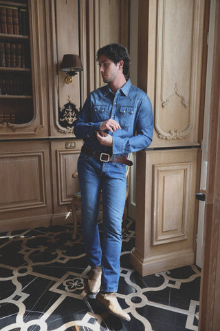 Lifestyle angled view of the Barbanera Carlito cloud blue denim shirt worn casually, showcasing its fit, texture, and detailed stitching.
