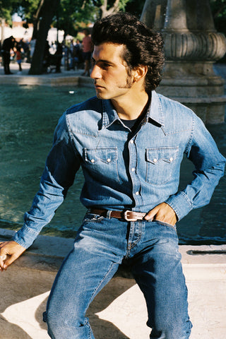 Model wearing the Barbanera Carlito cloud blue denim shirt in a lifestyle setting, showcasing its slim Western fit and soft denim texture.