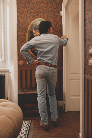 Rear lifestyle view of the Barbanera Carlito light blue denim shirt, showcasing the back yoke, slim fit, and faded denim texture.