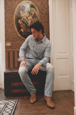 Lifestyle image of the Barbanera Carlito light blue denim shirt, highlighting its vintage wash, Western-inspired design, and casual silhouette.