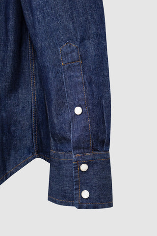Close-up of the cuff detail on the Barbanera Carlito raw denim shirt, highlighting precise stitching, button closure, and the texture of the raw denim fabric.