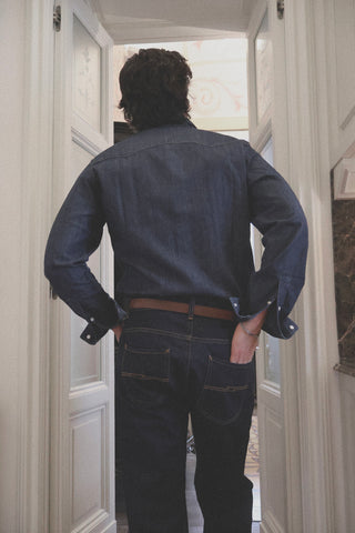 Lifestyle view of the back of the Barbanera Carlito raw denim shirt, highlighting its fit, stitching, and raw denim texture.