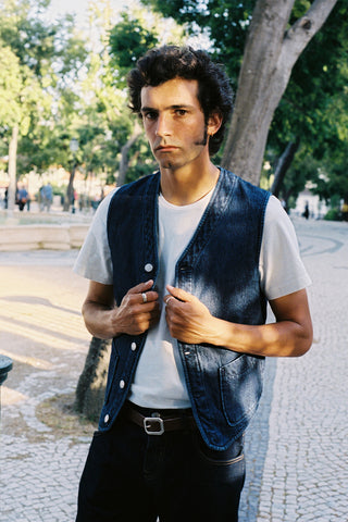 Side view lifestyle photo of the Barbanera Dane denim vest in deep blue, highlighting the vest’s silhouette, stitching, and texture while worn casually.