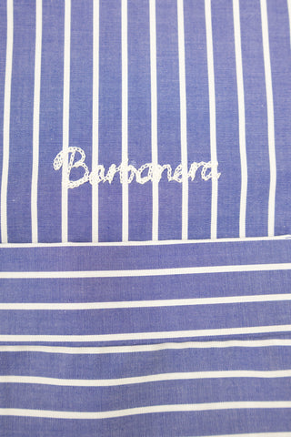 Close-up of the chainstitch logo embroidered on the Barbanera Earl bowling shirt in navy blue with white stripes, showcasing fine craftsmanship and detail.
