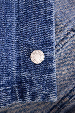 Close-up of a stud button on the Barbanera Fallen Cloud blue jacket, highlighting the metallic finish, engraved detailing, and precise stitching.