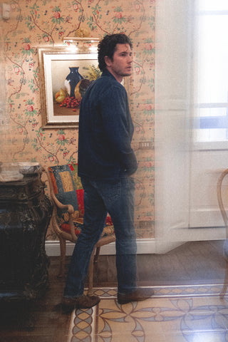 Side-back angled lifestyle shot of the Barbanera Jericho dark rinsed overshirt, highlighting the garment’s fit, shoulder seam, and subtle fading on the denim fabric.