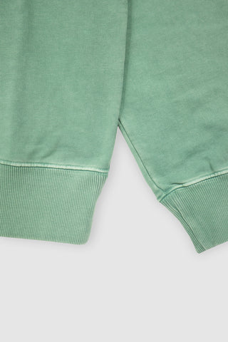 Close-up of the ribbed cuff and hem on the Barbanera Magic aqua green vintage sweatshirt, showing the textured knit and garment's aged finish.