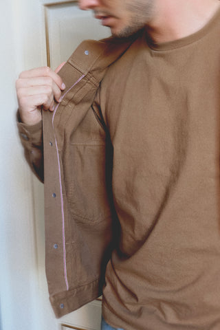 Lifestyle close-up of the Barbanera Neil camel denim jacket showcasing the selvedge edge detail, highlighting premium craftsmanship and fabric texture.