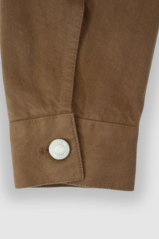 Close-up of the cuff on the Barbanera Neil camel selvedge denim jacket, featuring a metal button closure and detailed stitching on the selvedge denim fabric.