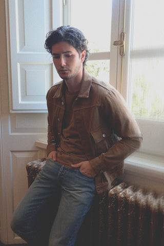 Lifestyle angled view of the Barbanera Neil camel selvedge denim jacket highlighting the structured cut, pocket design, and rich camel tone from a side perspective.