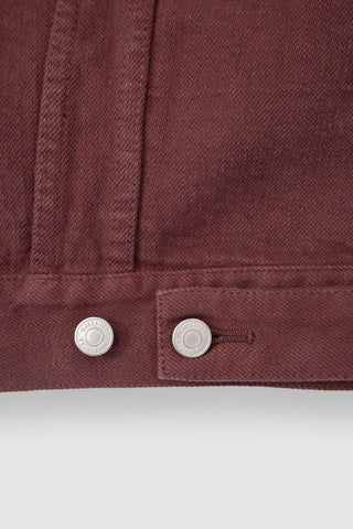 Close-up of the adjustable tabs on the back of the Barbanera Neil dark red selvedge denim jacket, showing metal hardware and detailed stitching.