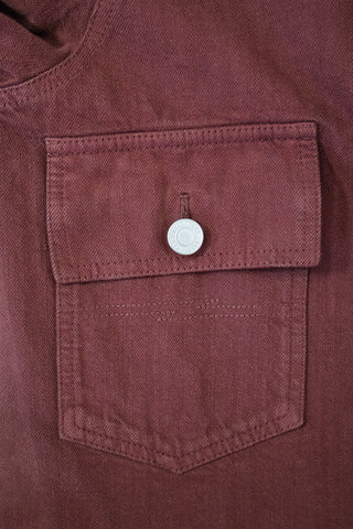 Close-up of the chest pocket on the Barbanera Neil dark red selvedge denim jacket, highlighting the flap design, button closure, and denim texture.