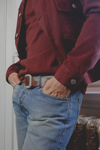 Lifestyle close-up of the Barbanera Neil dark red selvedge denim jacket, highlighting the texture of the fabric, stitching, and metal buttons.