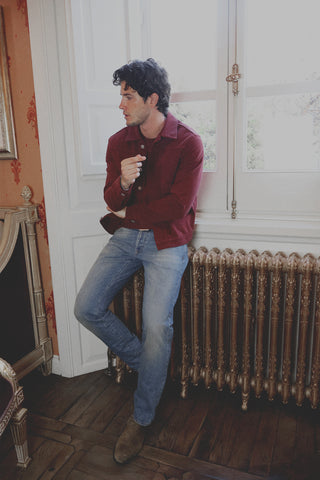 Lifestyle front view of the Barbanera Neil dark red selvedge denim jacket worn indoors, showcasing the jacket’s rich color, structured fit, and metal button details.