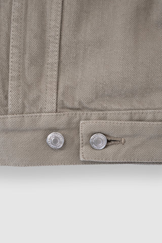 Close-up of the back adjusters on the Barbanera Neil sand selvedge denim jacket, featuring metal buttons and reinforced stitching on the light sandy denim fabric.