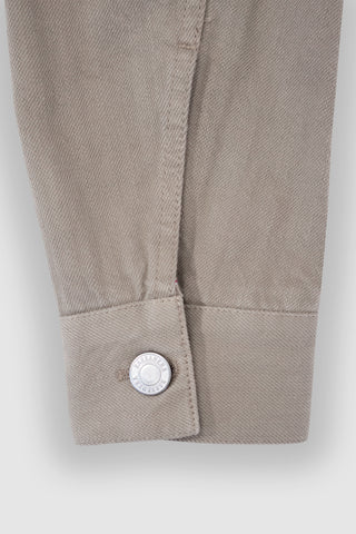 Close-up of the cuff on the Barbanera Neil sand selvedge denim jacket, highlighting button details, stitching, and the texture of the light sandy denim fabric.