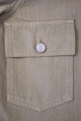 Close-up of the chest pocket on the Barbanera Neil sand selvedge denim jacket, showing the flap, stitching, and texture of the light sandy denim fabric.