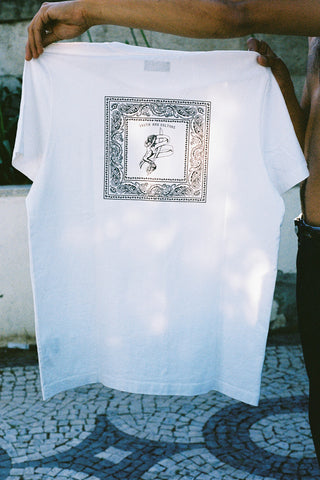 Casual lifestyle shot of a model wearing the Barbanera Vince blue bandana print tee, standing outdoors with natural light highlighting the vibrant bandana design on the white cotton tee.