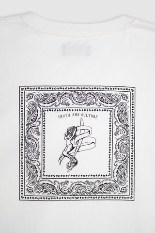 Close-up detail of the black bandana print on the Barbanera Vince tee, highlighting intricate paisley floral patterns and the logo mermaid on soft black raw cotton fabric.